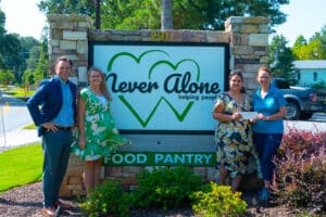 Bug Busters Donation to Never Alone Food Pantry
